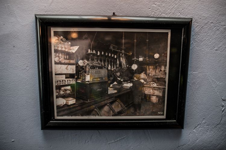 A historic photograph of the John P. Miller butcher shop that stood in this same building around 1900.